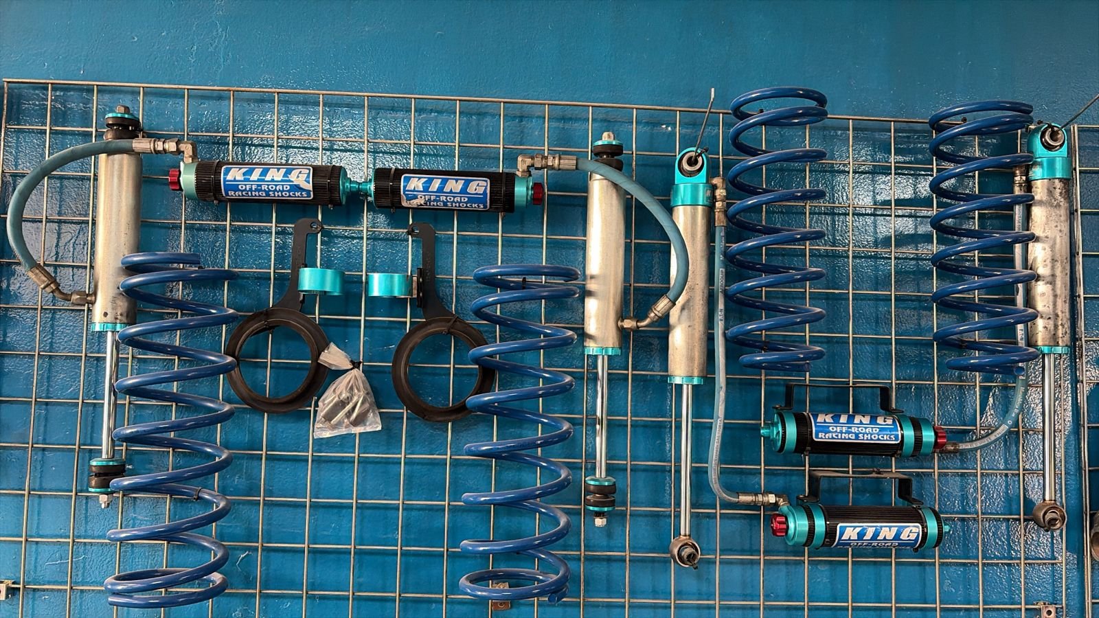 King Off-Road racing shocks and coil springs laid out during a rebuild